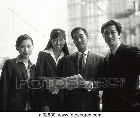 Male and female executives holding newspaper, buildings in background, portrait. View Large Photo Image Stock Image - Male and female executives holding newspaper, buildings in background, portrait.. Fotosearch