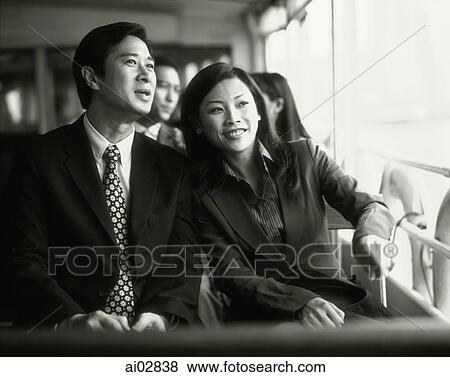 Male and female executives talking, sitting on ferry. View Large Photo Image Stock Photo - Male and female executives talking, sitting on ferry.. Fotosearch