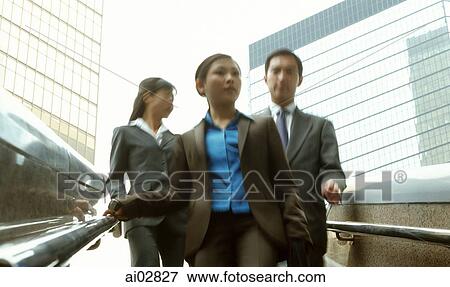 Male and female executives walking down stairs. View Large Photo Image Stock Photo - Male and female executives walking down stairs.. Fotosearch