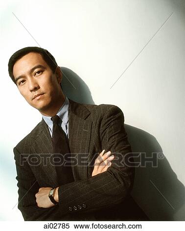 Stock Photography - Male executive against white background, portrait.. Fotosearch