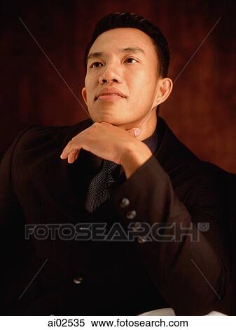 Male executive, hand on chin View Large Photo Image Stock Photography - Male executive, hand on chin. Fotosearch
