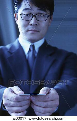 Stock Photo - Male executive handing out namecard. Fotosearch
