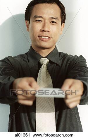 Male executive holding out business card. View Large Photo Image Stock Image - Male executive holding out business card.. Fotosearch