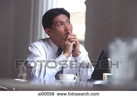 Male executive in cafe, thoughtful expression View Large Photo Image Stock Photo - Male executive in cafe, thoughtful expression. Fotosearch