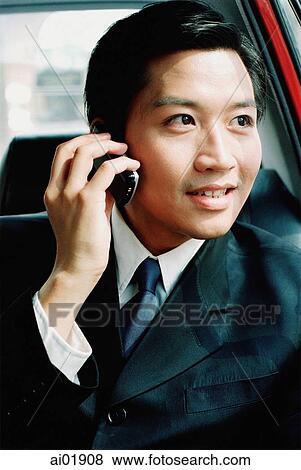 Male executive in car, talking on cellular phone View Large Photo Image Stock Photo - Male executive in car, talking on cellular phone. Fotosearch