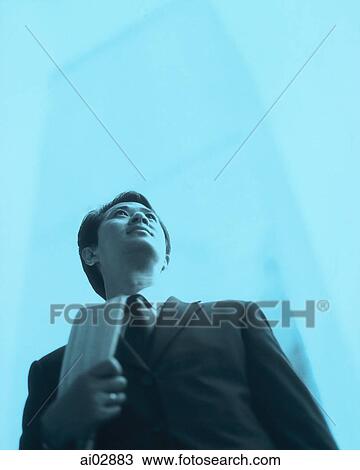 Male executive looking away, building in background. View Large Photo Image Stock Image - Male executive looking away, building in background.. Fotosearch