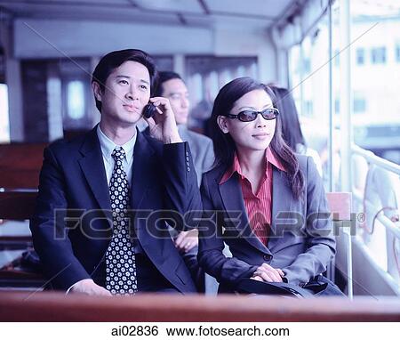 Male executive on cellular phone with female next to him, outdoors. View Large Photo Image Stock Photograph - Male executive on cellular phone with female next to him, outdoors.. Fotosearch