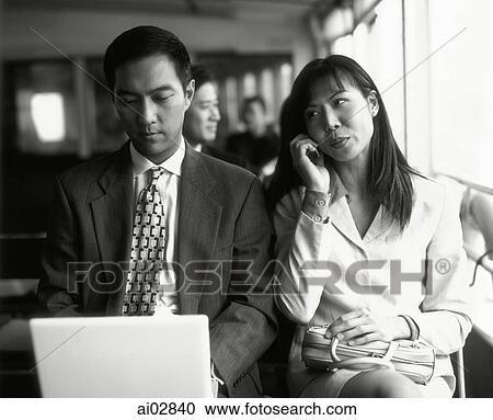 Male executive on laptop, female on cellular phone. View Large Photo Image Stock Image - Male executive on laptop, female on cellular phone.. Fotosearch