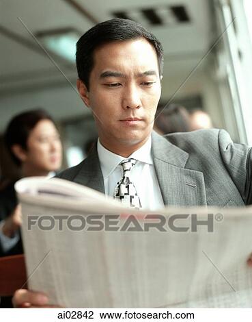 Male executive reading newspaper. View Large Photo Image Stock Image - Male executive reading newspaper.. Fotosearch