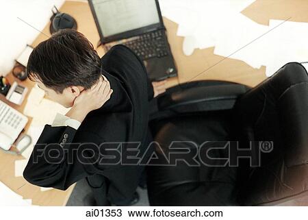 Male executive sitting at desk, top view. View Large Photo Image Stock Image - Male executive sitting at desk, top view.. Fotosearch