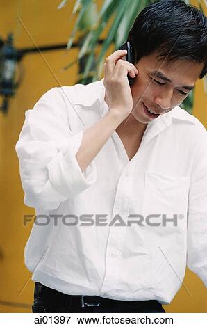 Male executive talking on cellular phone View Large Photo Image Stock Photo - Male executive talking on cellular phone. Fotosearch