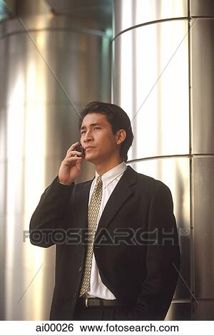 Stock Photograph - Male executive talking on cellular phone. Fotosearch