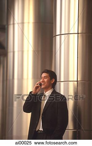 Male executive talking on cellular phone View Large Photo Image Stock Photography - Male executive talking on cellular phone. Fotosearch