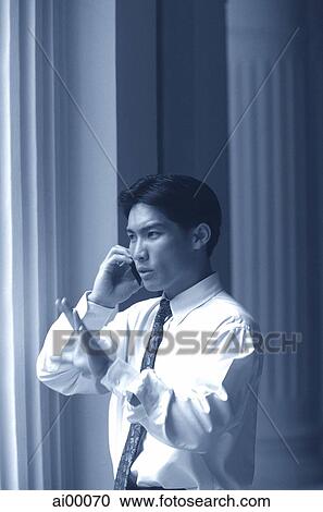 Male executive talking on cellular phone, pillars behind View Large Photo Image Stock Image - Male executive talking on cellular phone, pillars behind. Fotosearch