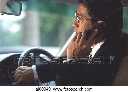 Male executive talking on cellular phone in car, profile View Large Photo Image Stock Photo - Male executive talking on cellular phone in car, profile. Fotosearch