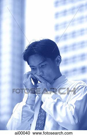 Male executive using cellular phone, thoughtful expression View Large Photo Image Stock Image - Male executive using cellular phone, thoughtful expression. Fotosearch