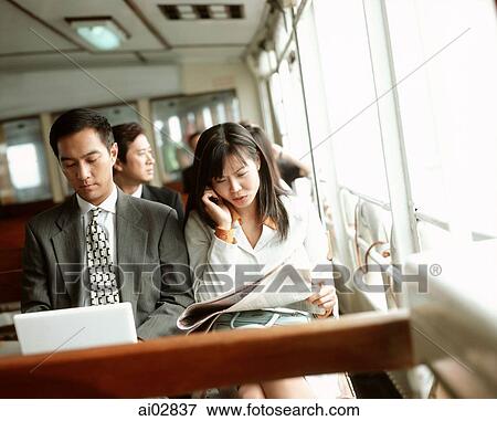 Male executive using laptop, female using cellular phone, outdoors. View Large Photo Image Stock Photo - Male executive using laptop, female using cellular phone, outdoors.. Fotosearch