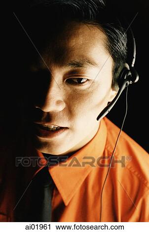 Male executive using telephone headset, portrait View Large Photo Image Stock Image - Male executive using telephone headset, portrait. Fotosearch