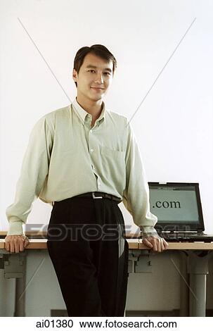 Male executive with laptop computer behind. View Large Photo Image Stock Image - Male executive with laptop computer behind.. Fotosearch