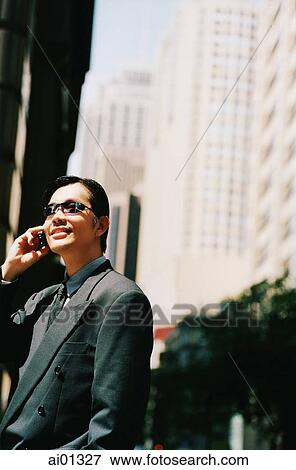 Male executive with sunglasses, using cellular phone View Large Photo Image Stock Photo - Male executive with sunglasses, using cellular phone. Fotosearch