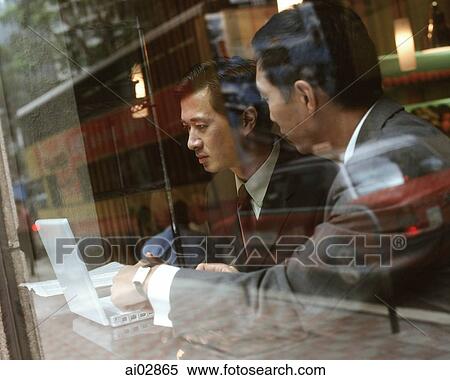 Male executives using laptop seen through glass window. View Large Photo Image Stock Photography - Male executives using laptop seen through glass window.. Fotosearch