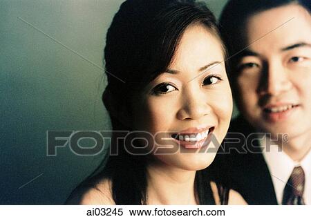 Stock Photography - Man and woman smiling, portrait ( high grain). Fotosearch