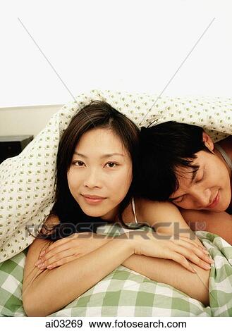 Man and woman under covers, portrait View Large Photo Image Stock Photo - Man and woman under covers, portrait. Fotosearch