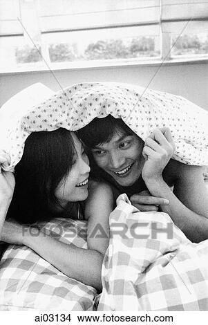 Man and woman under sheet, talking View Large Photo Image Picture - Man and woman under sheet, talking. Fotosearch