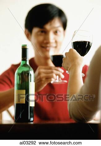 Stock Image - Man drinking wine with friend. Fotosearch