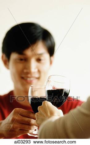 Stock Image - Man drinking wine with friend. Fotosearch