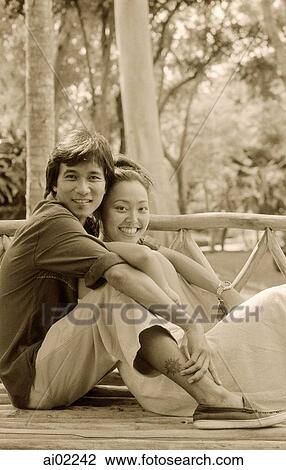 Man embracing woman on bench outdoors View Large Photo Image Stock Image - Man embracing woman on bench outdoors. Fotosearch