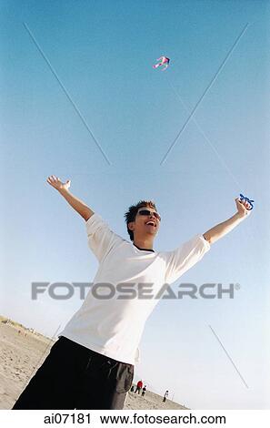 Man flying kite ( high grain) View Large Photo Image Stock Image - Man flying kite ( high grain). Fotosearch