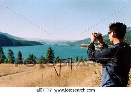Man holding camera View Large Photo Image Stock Photo - Man holding camera. Fotosearch