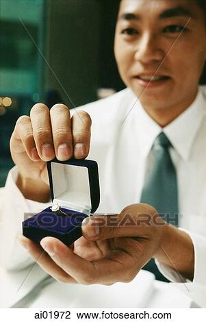 Man holding engagement ring View Large Photo Image Stock Image - Man holding engagement ring. Fotosearch