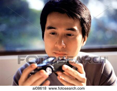 Man holding toy model car, looking. View Large Photo Image Stock Photo - Man holding toy model car, looking.. Fotosearch