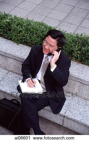 Man in business suit, using mobile phone View Large Photo Image Stock Image - Man in business suit, using mobile phone. Fotosearch