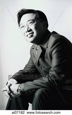 Man in dark color suit sitting, smiling. View Large Photo Image Stock Image - Man in dark color suit sitting, smiling.. Fotosearch