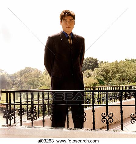 Man in suit, standing View Large Photo Image Stock Image - Man in suit, standing. Fotosearch