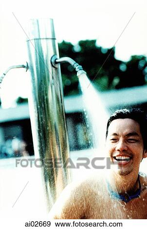 Man laughing under poolside shower View Large Photo Image Stock Photo - Man laughing under poolside shower. Fotosearch