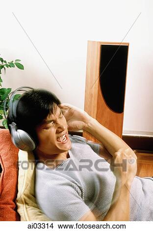 Man listening to headphones View Large Photo Image Picture - Man listening to headphones. Fotosearch