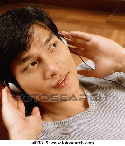 Man listening to headphones View Large Photo Image Stock Photography - Man listening to headphones. Fotosearch