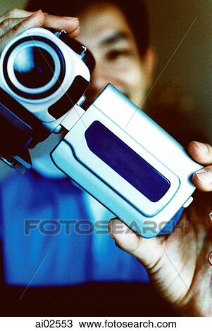 Man looking into screen of camcorder View Large Photo Image Stock Image - Man looking into screen of camcorder. Fotosearch