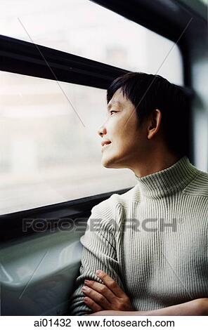 Man looking out window View Large Photo Image Stock Image - Man looking out window. Fotosearch