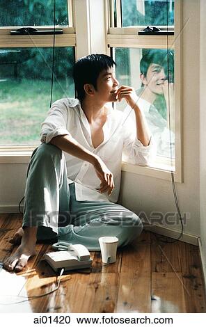 Man looking out window with chin on hand View Large Photo Image Stock Image - Man looking out window with chin on hand. Fotosearch