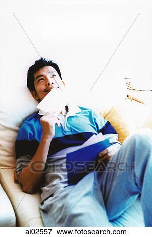 Stock Photo - Man lying down, looking up. Fotosearch