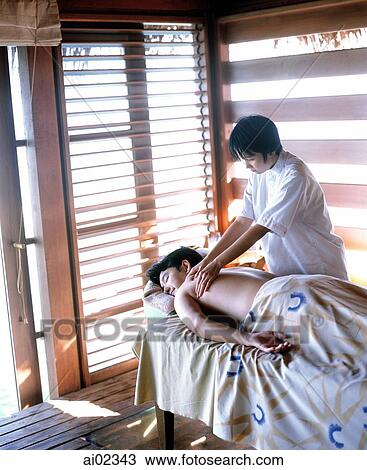 Man on table getting a massage from woman View Large Photo Image Stock Image - Man on table getting a massage from woman. Fotosearch