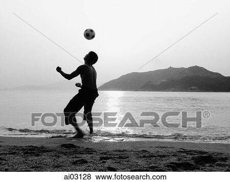 Man playing with football (soccer ball) on beach, silhouette View Large Photo Image Stock Photo - Man playing with football (soccer ball) on beach, silhouette. Fotosearch