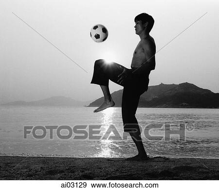 Man playing with football (soccer ball) on beach, silhouette View Large Photo Image Stock Photo - Man playing with football (soccer ball) on beach, silhouette. Fotosearch
