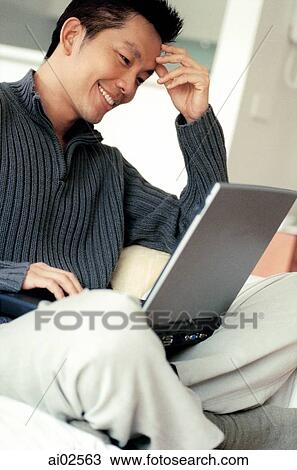 Man sitting cross-legged using laptop View Large Photo Image Stock Image - Man sitting cross-legged using laptop. Fotosearch