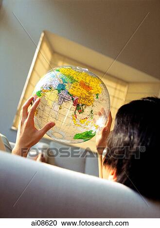 Man sitting, holding plastic globe, back view. View Large Photo Image Stock Image - Man sitting, holding plastic globe, back view.. Fotosearch